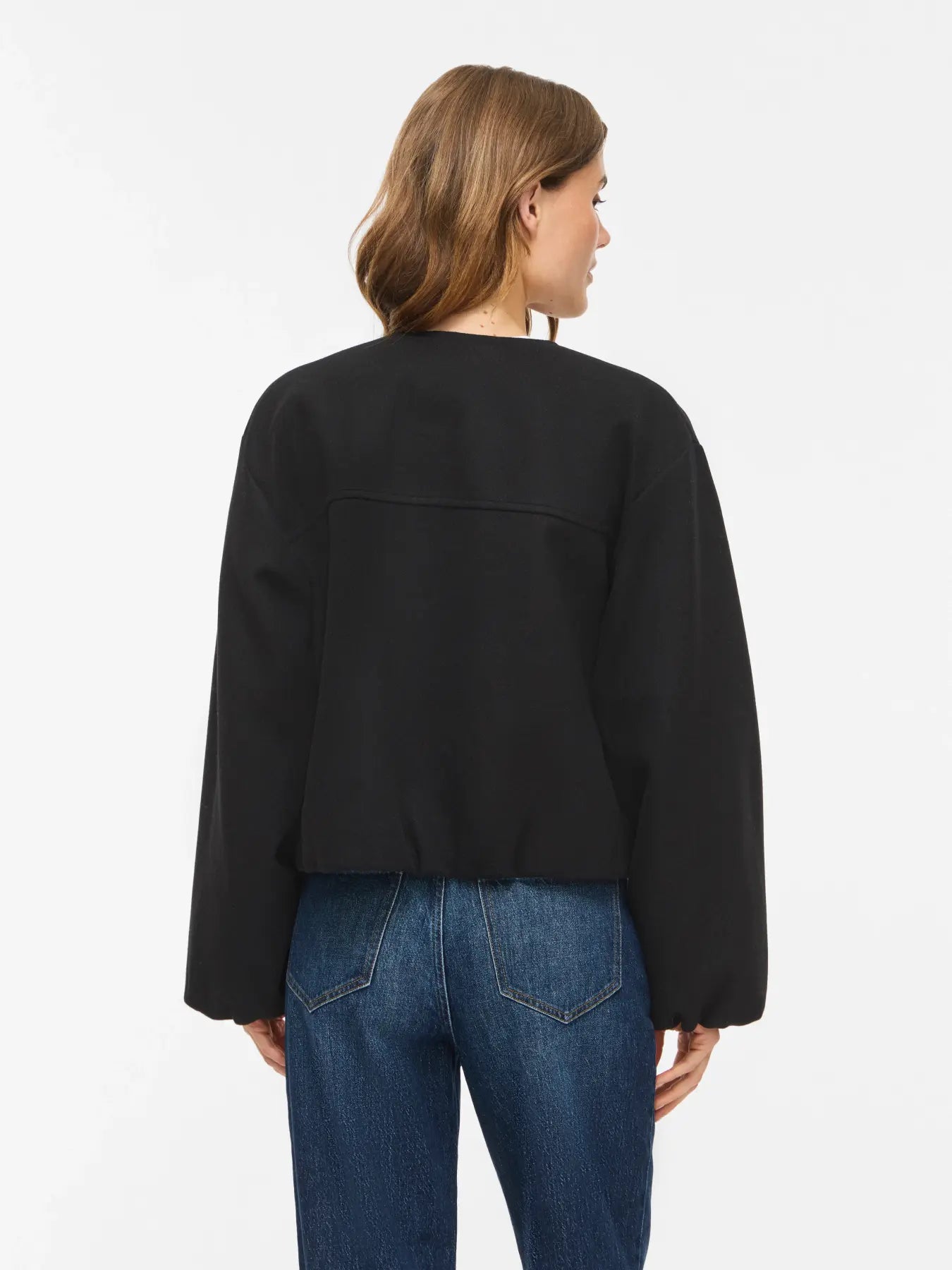 Vista trasera de la chaqueta Adele, volumen en bajo y corte canes