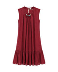 Vestido Lía azul marino de corte fluido con lazada y abalorios decorativos.